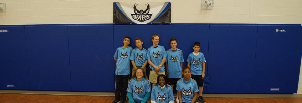 Male and female students wearing school sports team uniforms in the gym