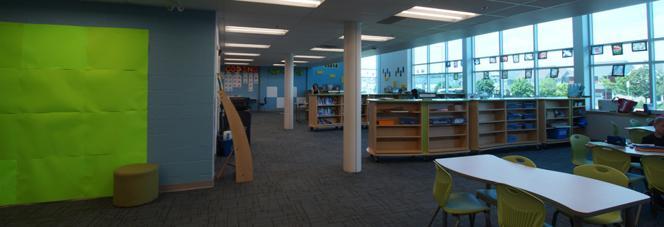 Learning Commons area of the school with books and tables